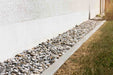 "1 ½” Local River Rock used in a landscaped garden or water feature"


