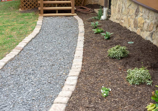 "1 ½” Mtn Granite used in a landscaped driveway or garden"

