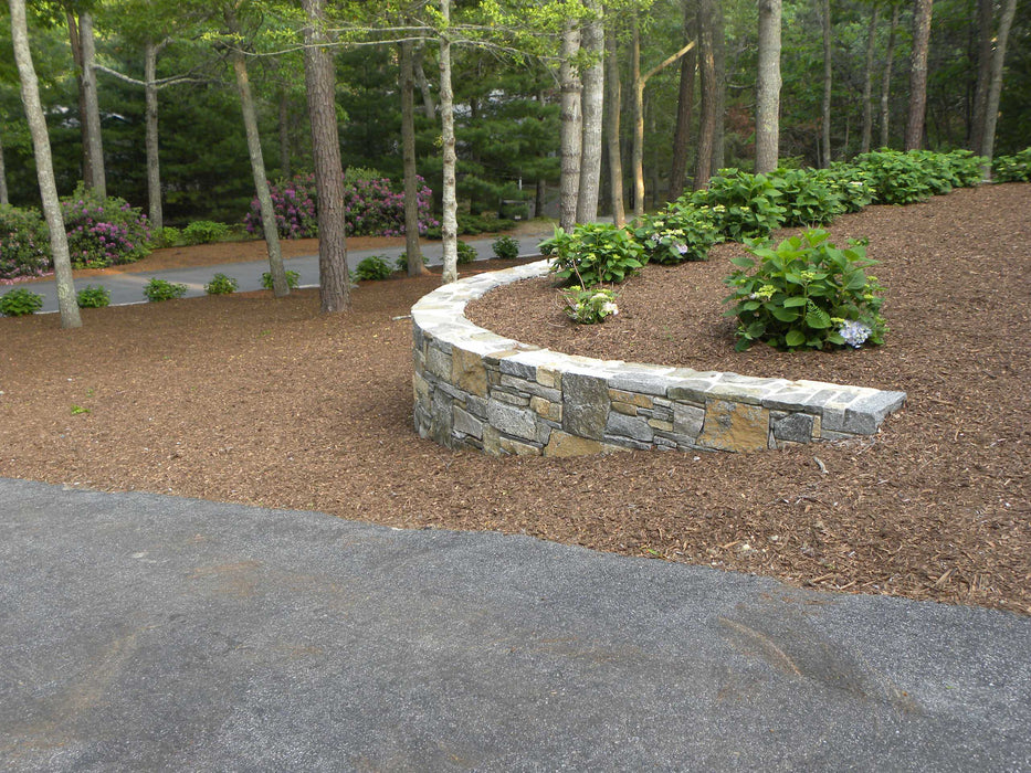 "Redwood Mulch used in a landscaped garden bed or tree ring"

